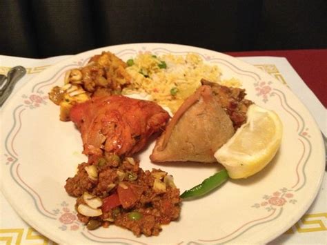 Two chicken and one vegetable curries, tandoori chicken, rice, raita, samosas. . Star of india ahwatukee